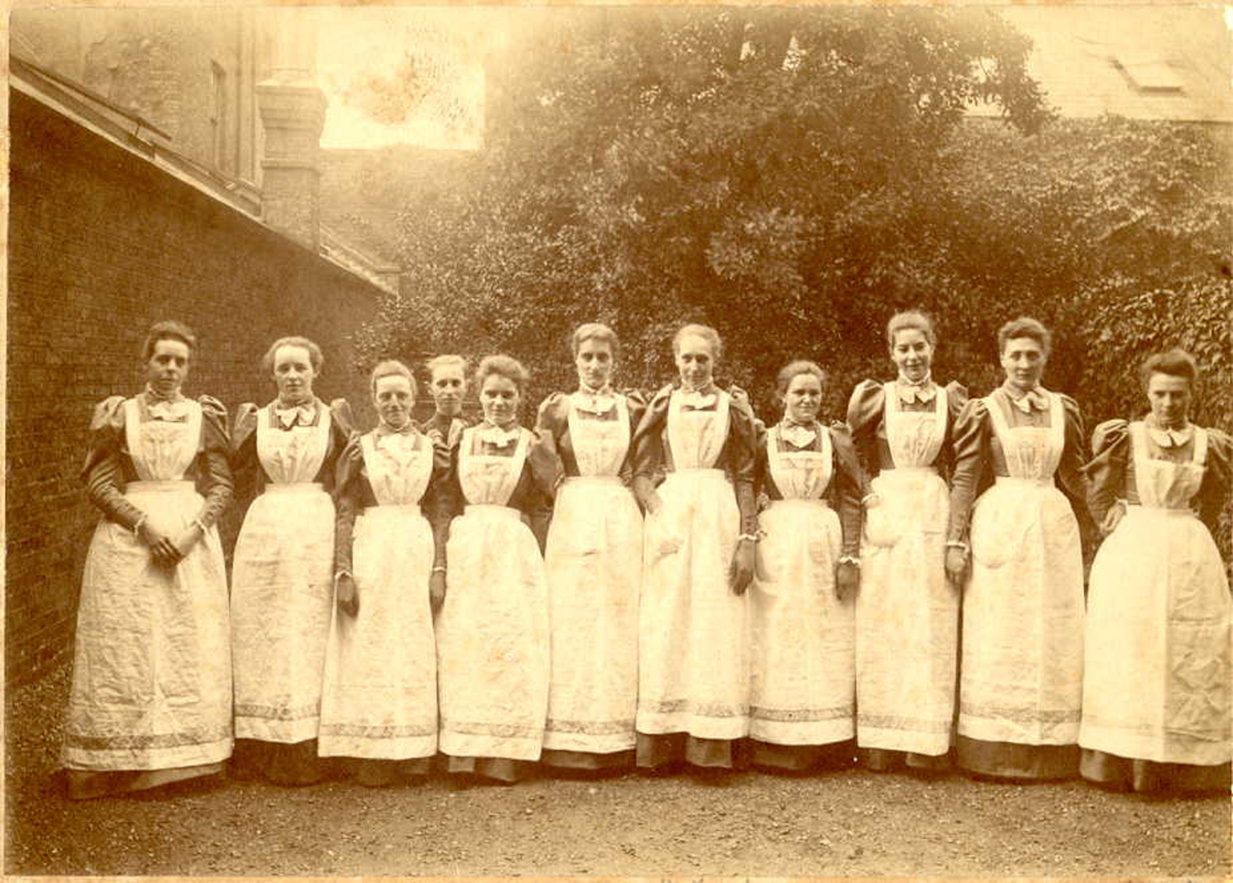This photo, 1892, depicts the first trained Norland Nannies wearing fashionable dresses with puffed gigot sleeves, the brown fabric distinguishing them from other domestic servants. -Norland College