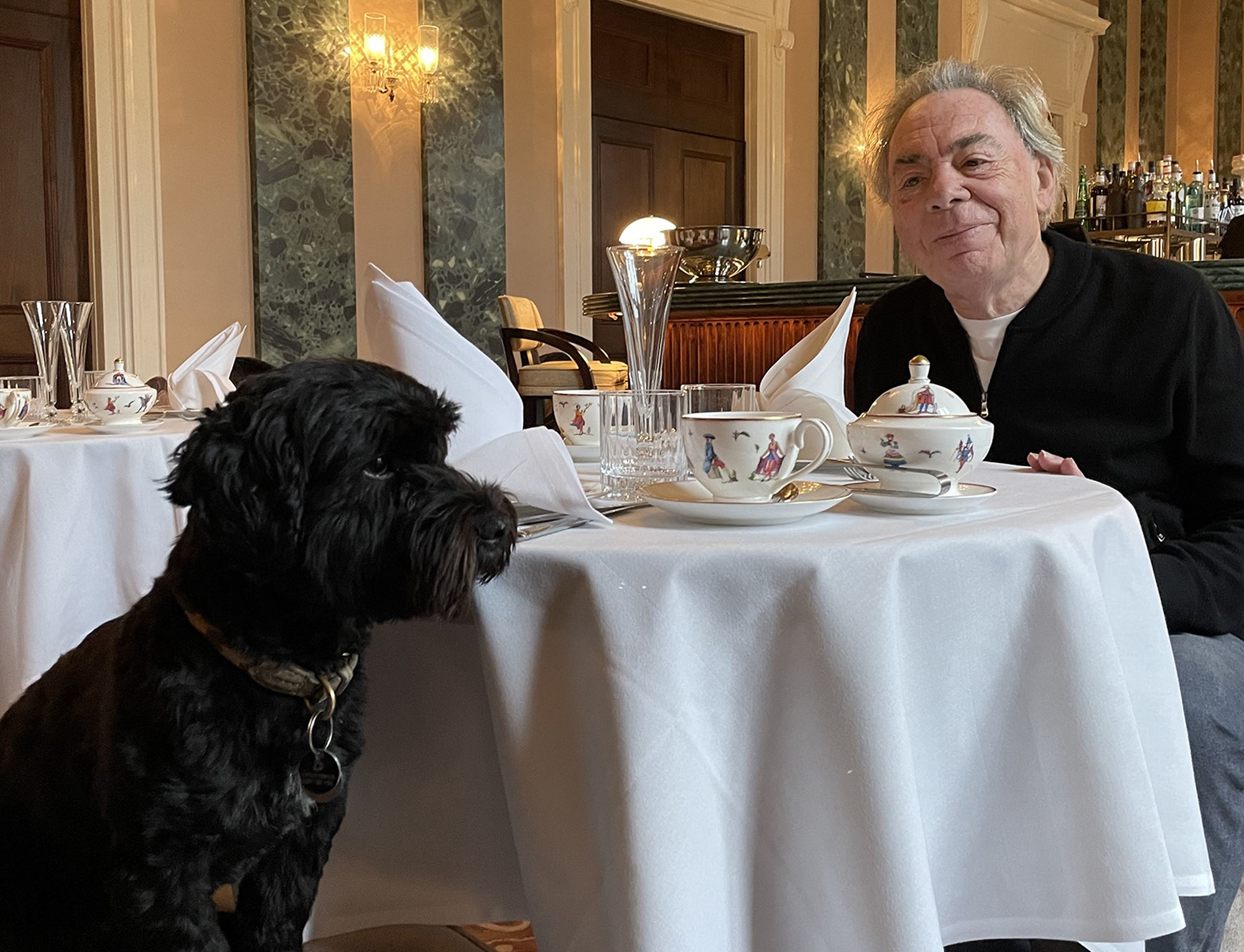 Andrew having afternoon tea with his dog, Mojito
