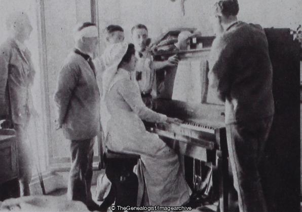 Entertaining the wounded in the countess of Dundonalds hospital sister the Hon Margaret Amherst plays to the patients (Belgravia, Countess of Dundonald, Eaton Square, England, Hospital, London, Nurse, Piano, Wounded)