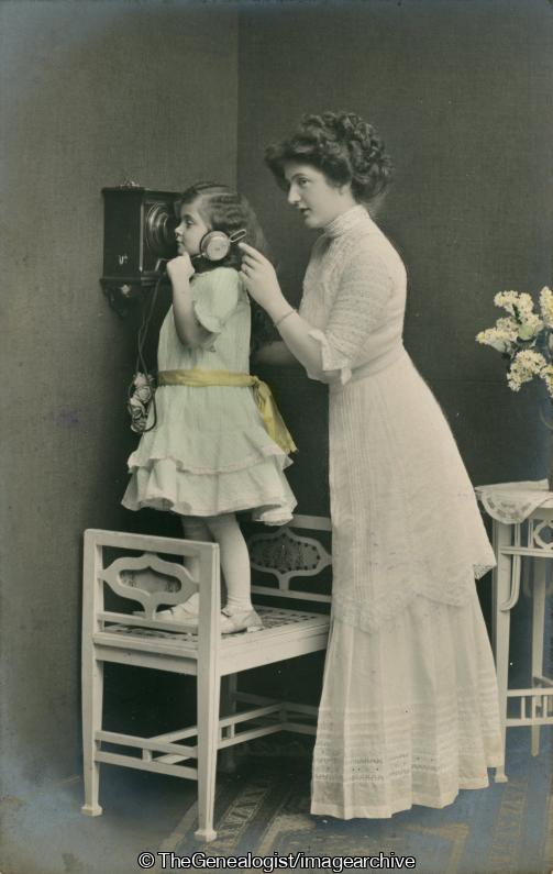 Mother at ready and daughter  standing on chair on phone C1900 (C1900, chair, daughter, flowers, Mother, Telephone)